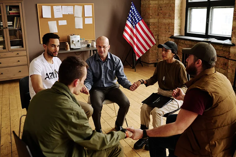 veterans holding hands support group
